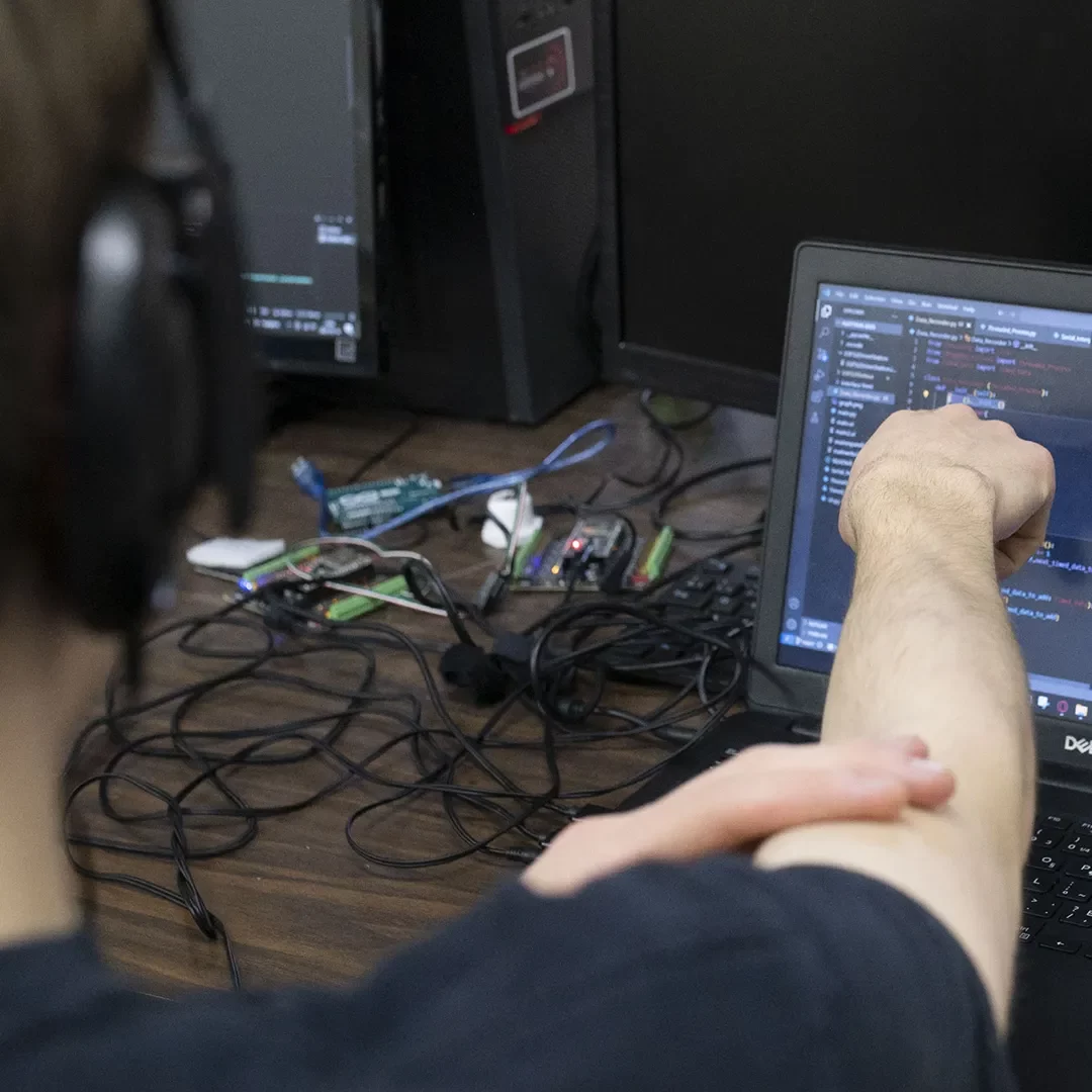 Un élève pointe un écran d'ordinateur.